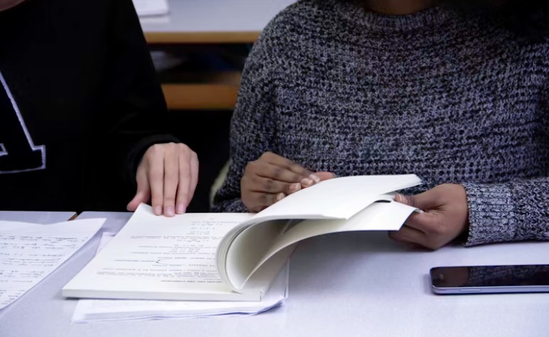 people reading from a textbook