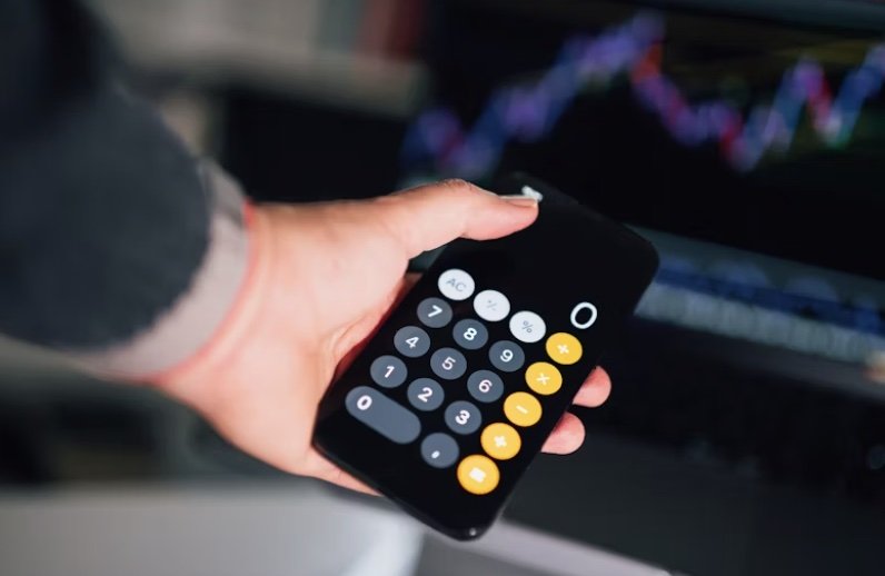 a person holding a calculator in their hand