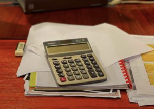 a calculator on a pile of paper