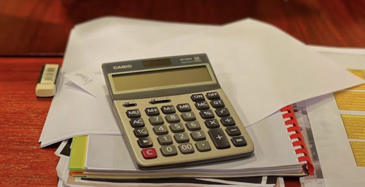 a calculator on a pile of paper