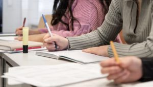 hands writing on a test sheet