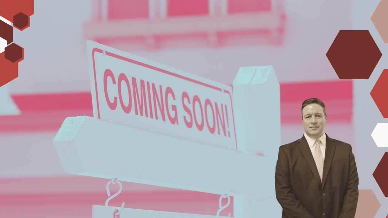 Joe Stephenson, a real estate agent, placing a 'Coming Soon' sign in front of a house