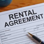 a pen on a rental agreement contract