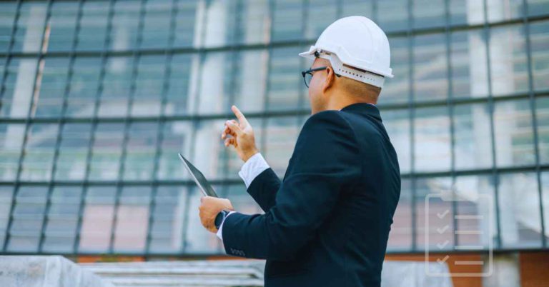 a person in front of a commercial building conducting a checklist