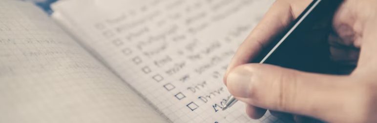 a person write on a checklist