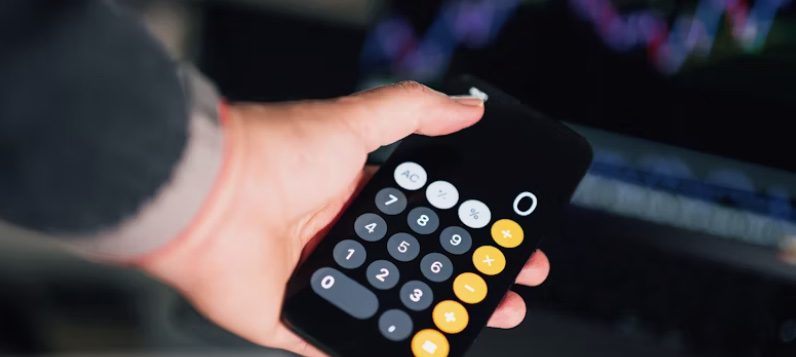 a person holding a calculator in their hand