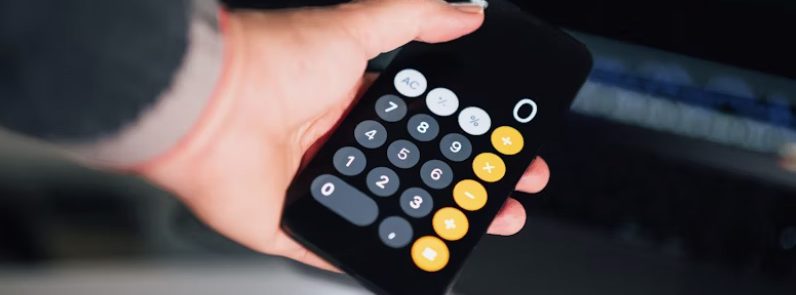 a person holding a calculator in their hand